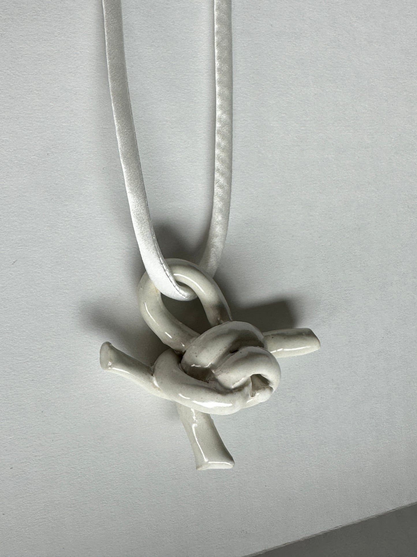 Ceramic knot pendant with silk cord in white