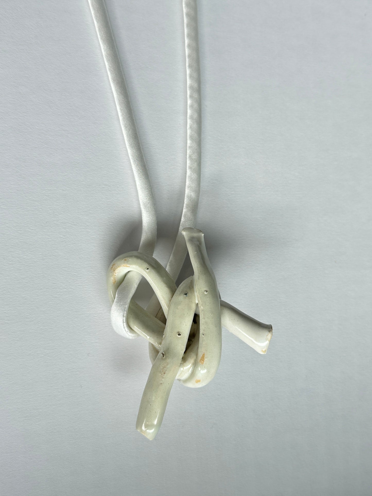 Ceramic knot pendant with silk cord in white