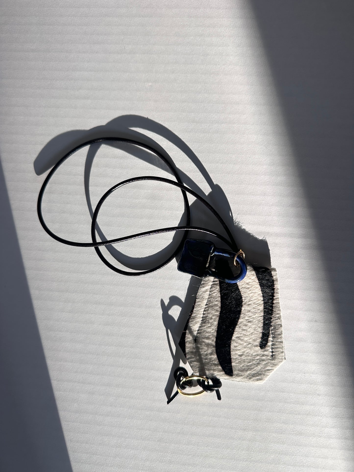 “Alice’s World” Leather Clotchette with ceramic padlock