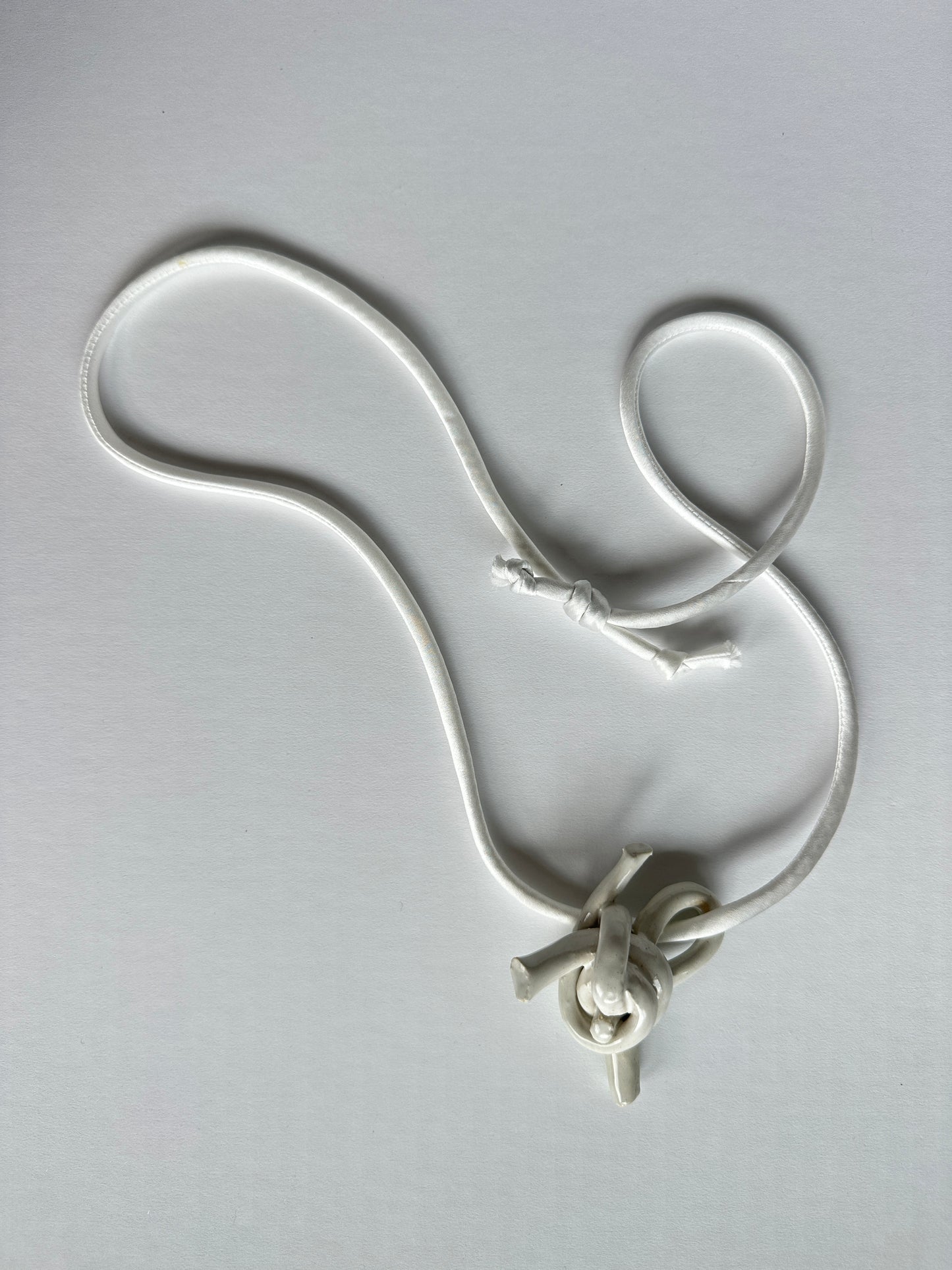 Ceramic knot pendant with silk cord in white