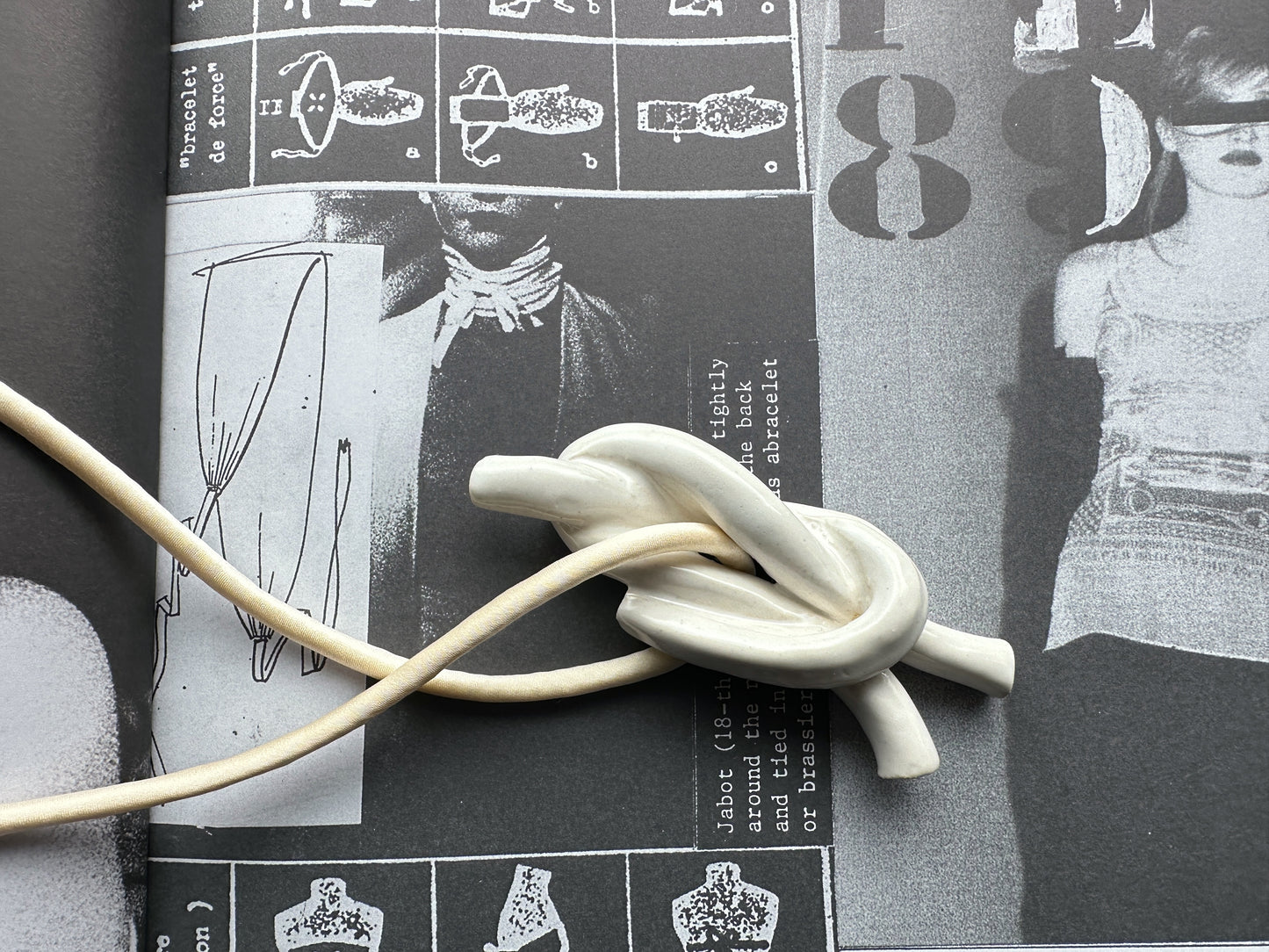 Ceramic knot pendant with ivory silk cord