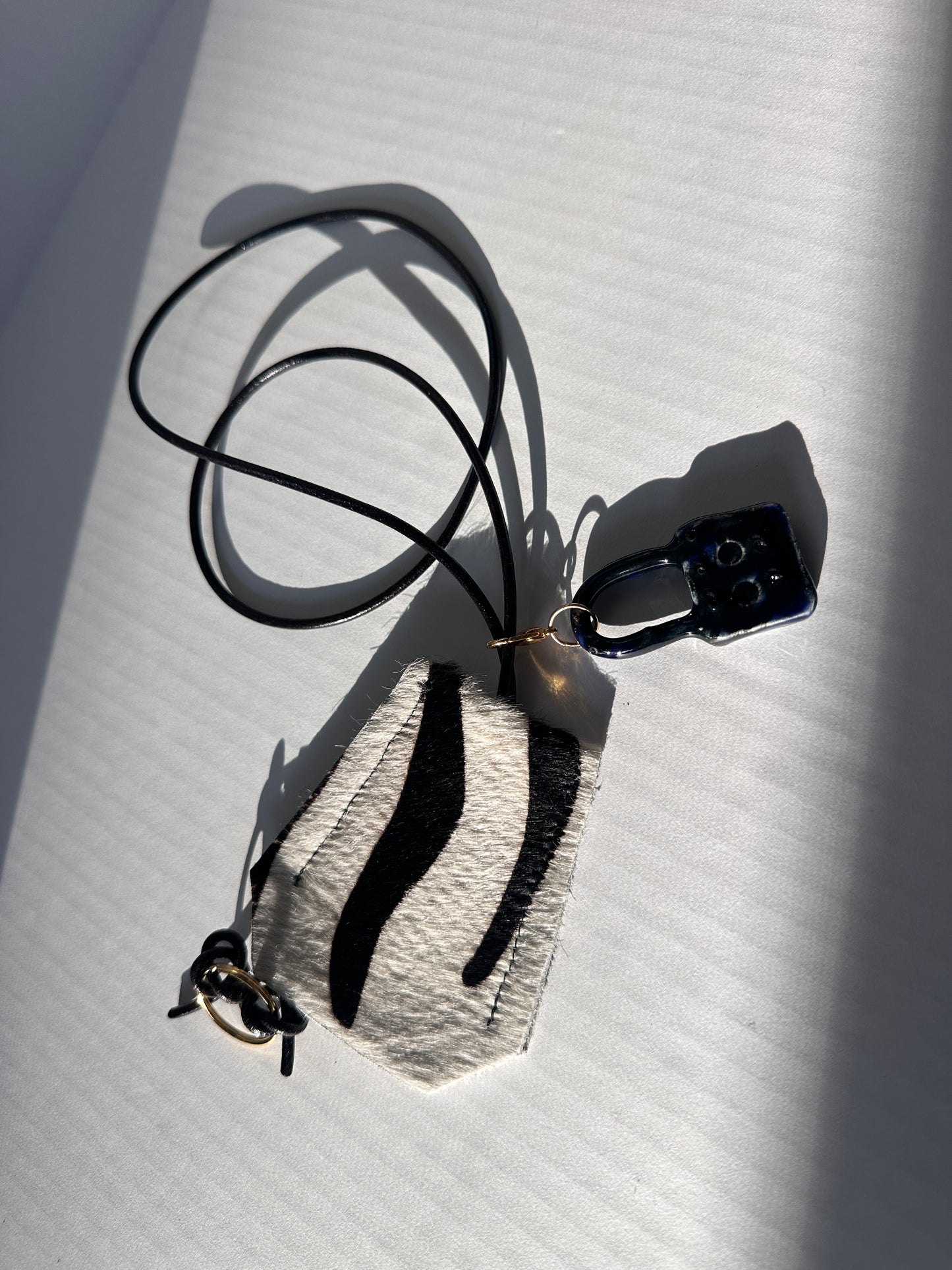 “Alice’s World” Leather Clotchette with ceramic padlock