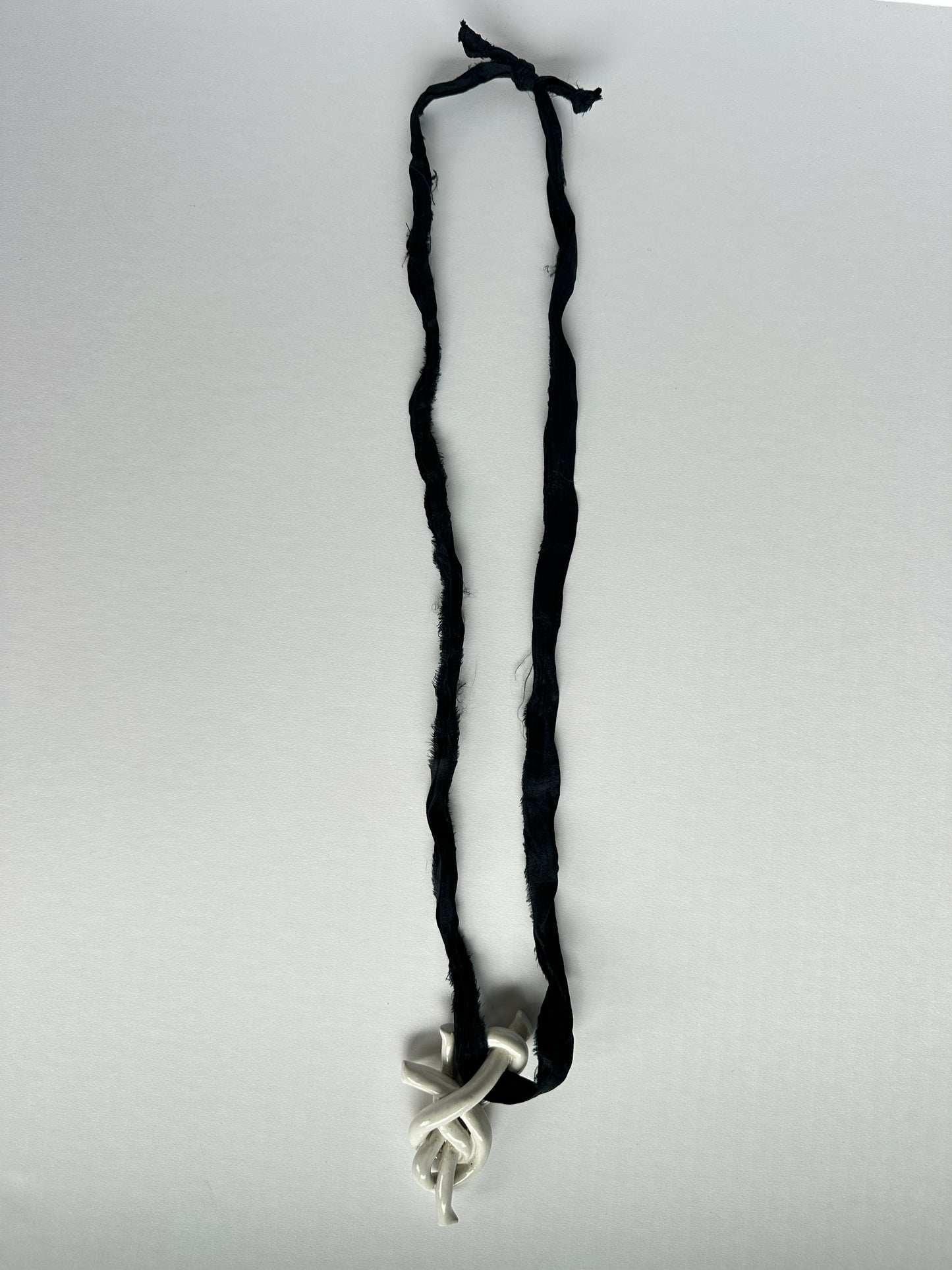Ceramic knot pendant with recycled sari silk cord in black