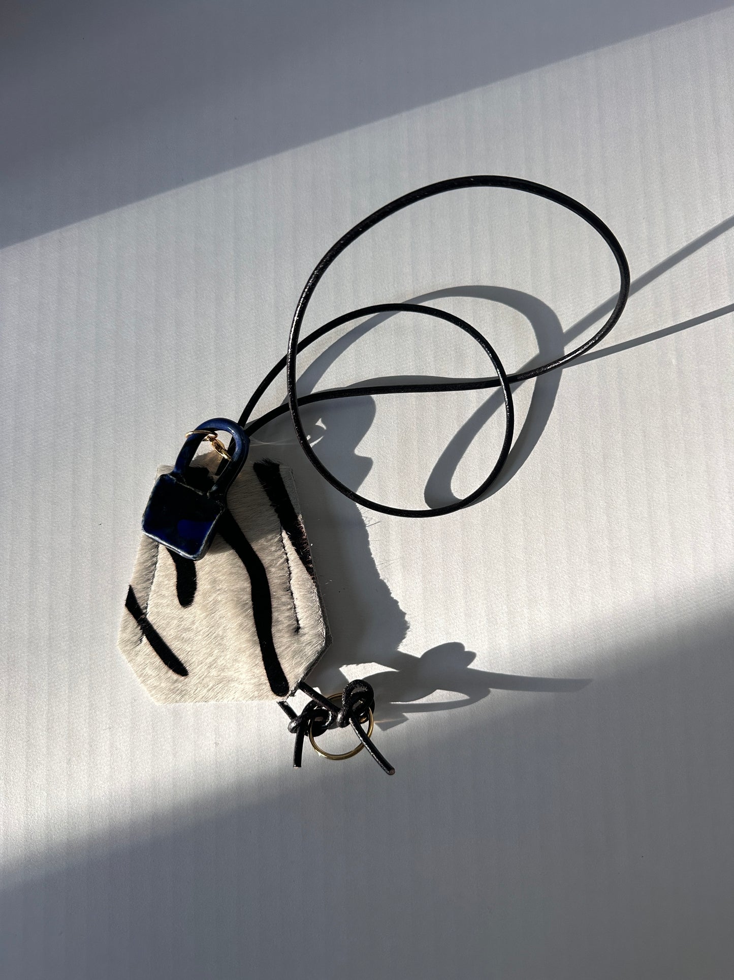 “Alice’s World” Leather Clotchette with ceramic padlock