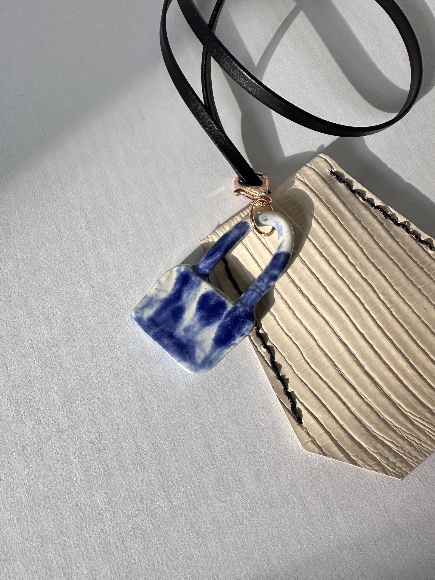 “Alice’s World” Leather Clochette with ceramic padlock