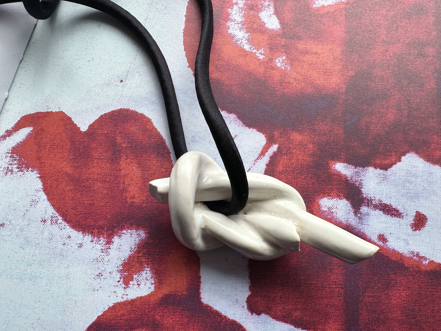 Ceramic knot pendant with black silk cord