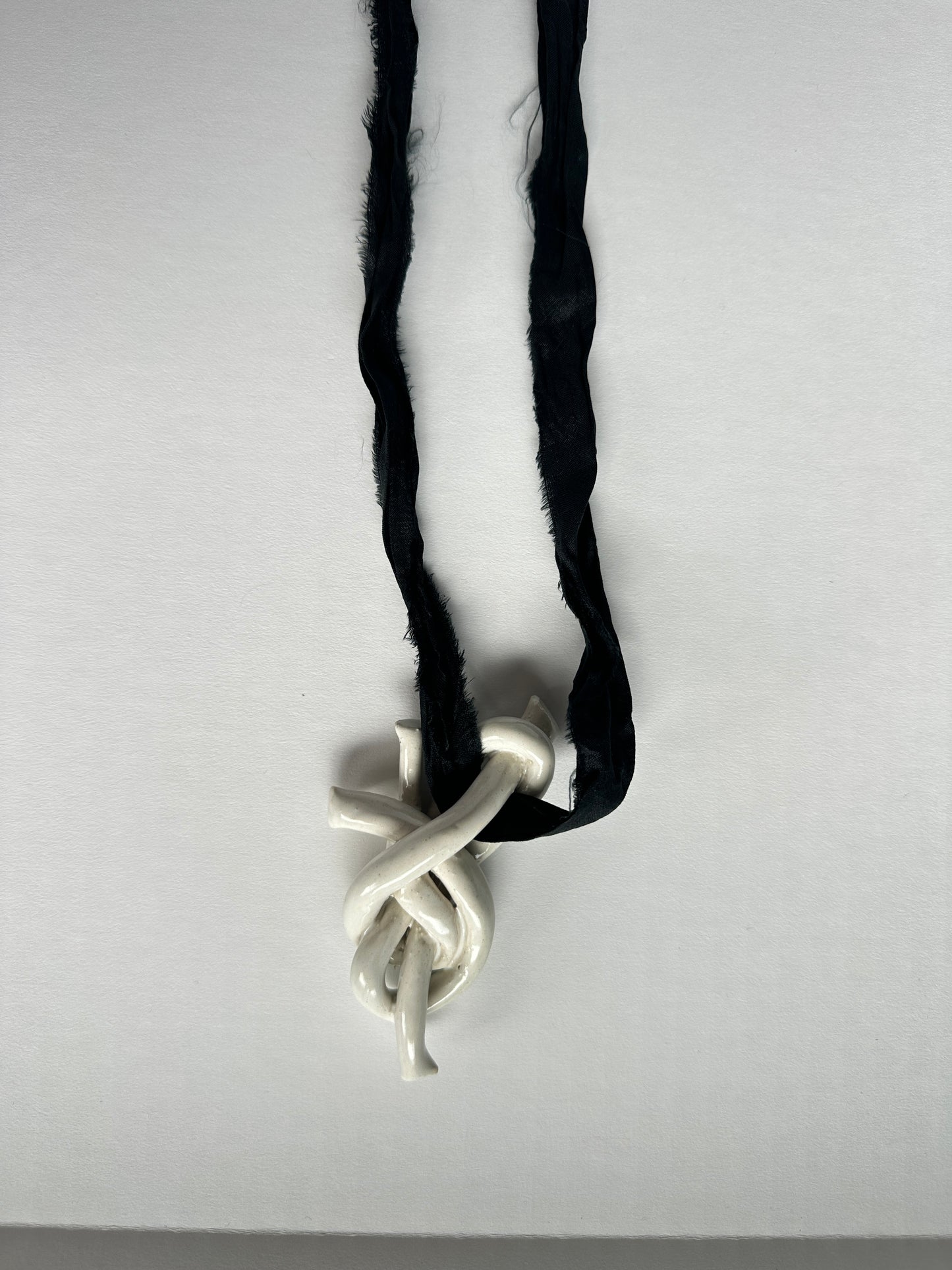 Ceramic knot pendant with recycled sari silk cord in black