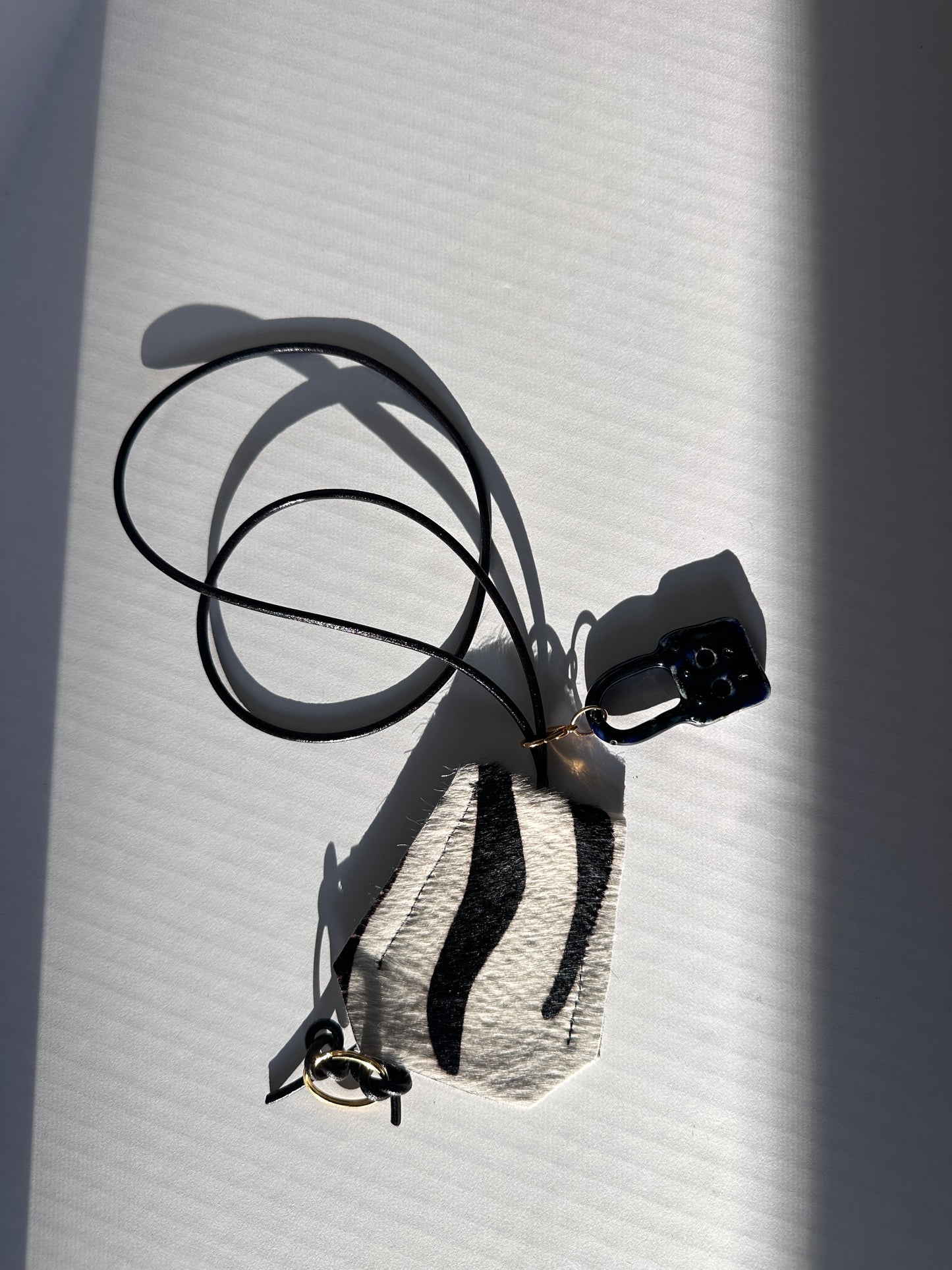 “Alice’s World” Leather Clotchette with ceramic padlock