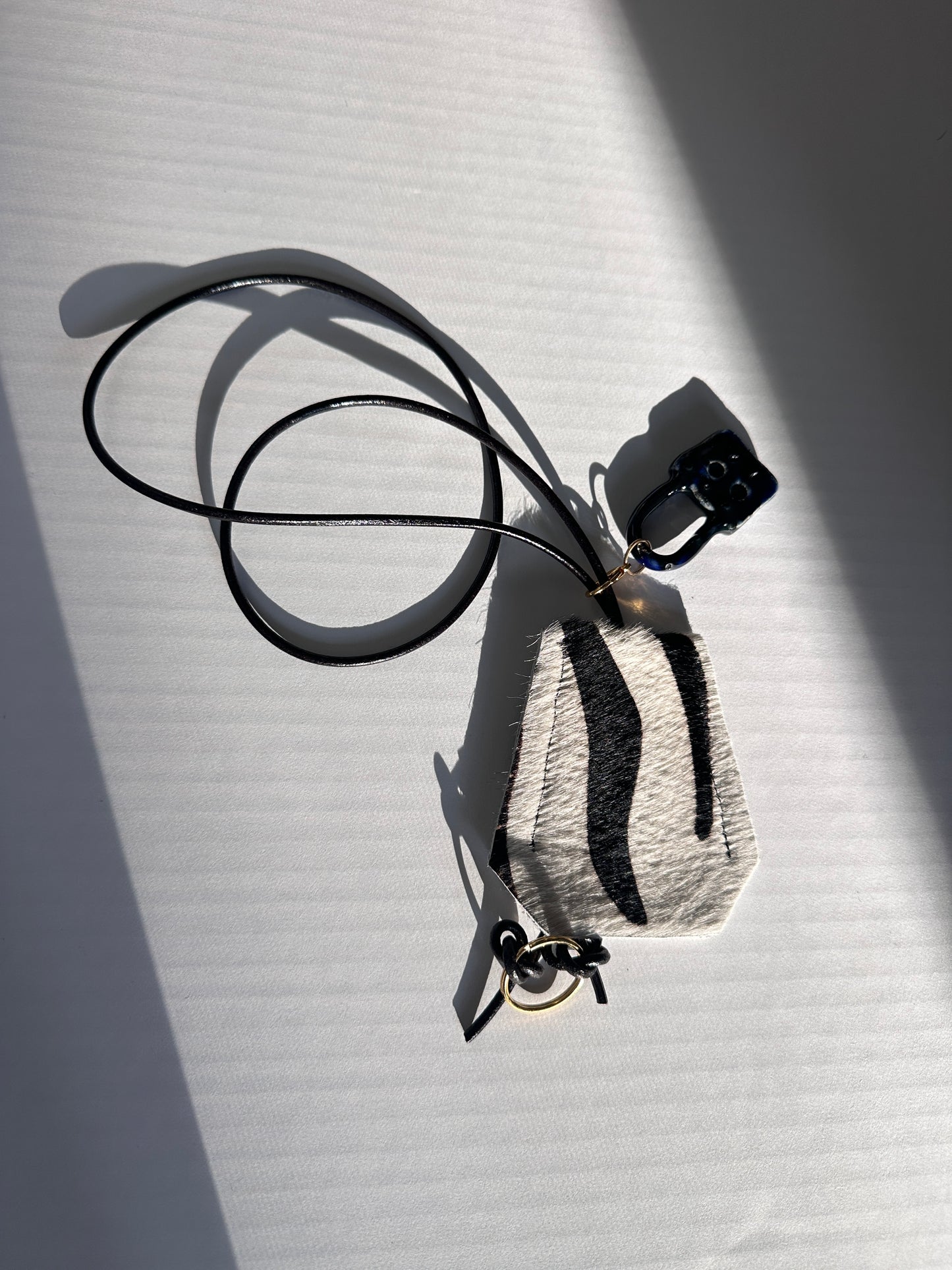 “Alice’s World” Leather Clotchette with ceramic padlock