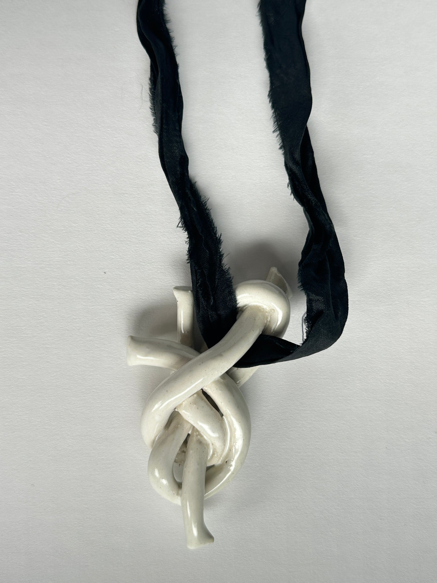 Ceramic knot pendant with recycled sari silk cord in black