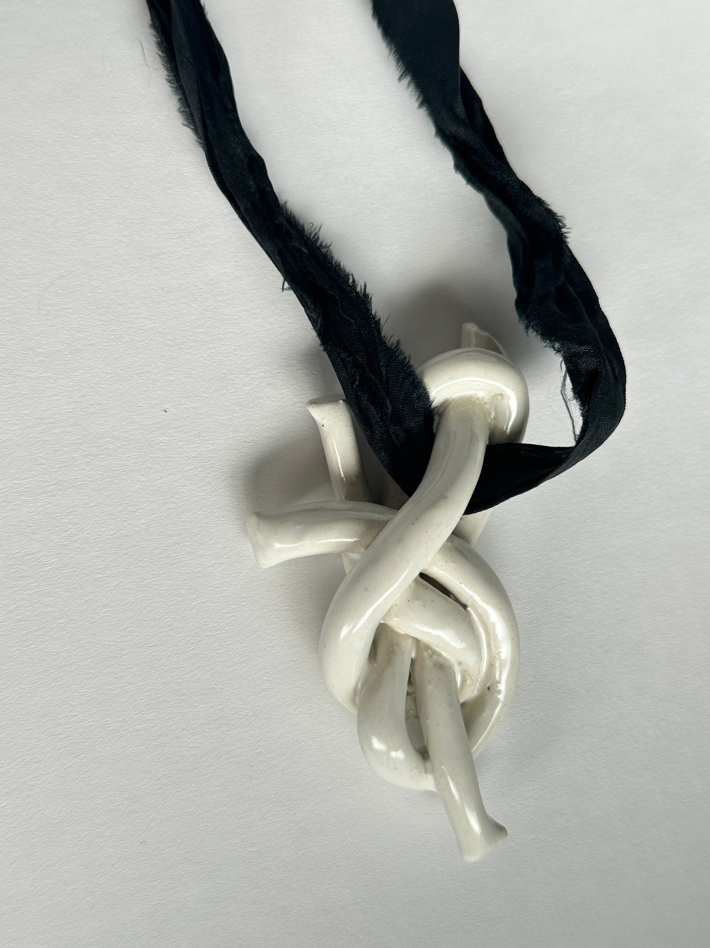 Ceramic knot pendant with recycled sari silk cord in black