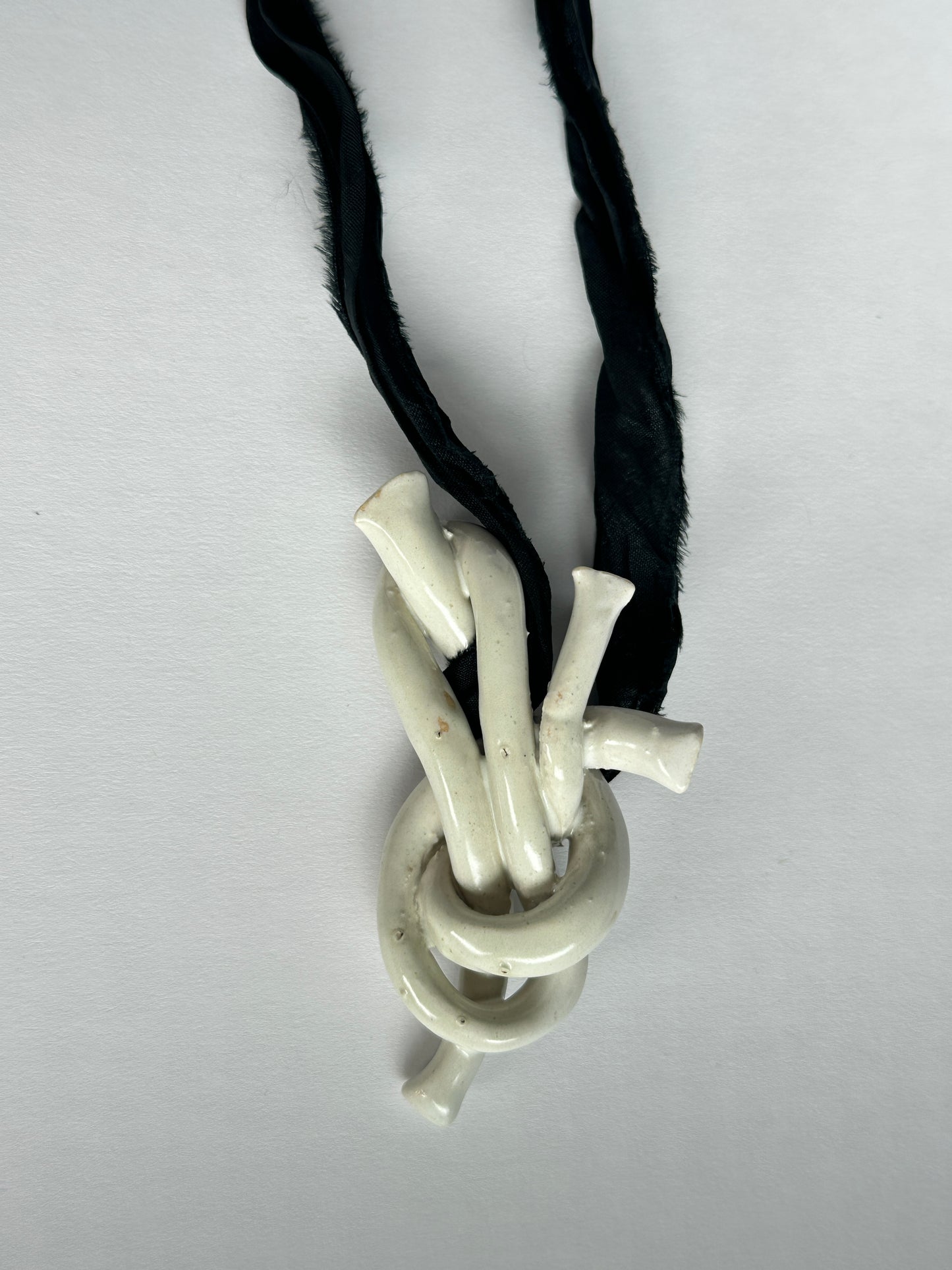 Ceramic knot pendant with recycled sari silk cord in black